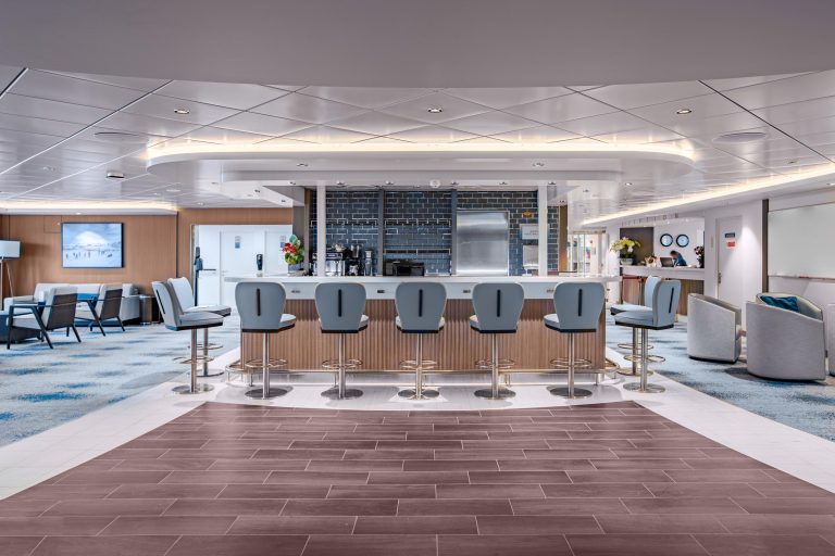 The Nordic Bar on Ocean Victory with 7 barstools and a lounge area to the side.