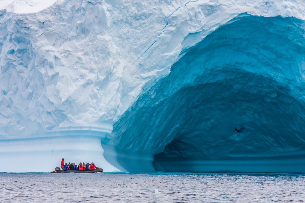 Zodiac,In,Front,Of,Enormous,Ice,Berg,In,Antarctica