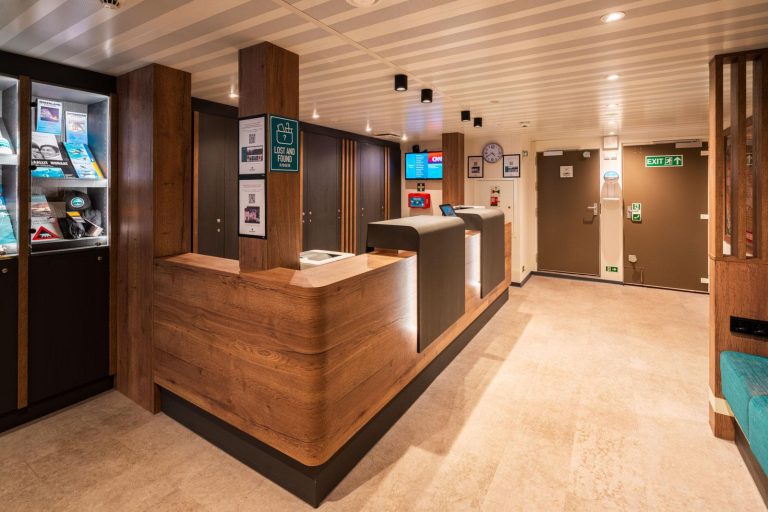 Wooden desk at reception area onboard the Ortelius.